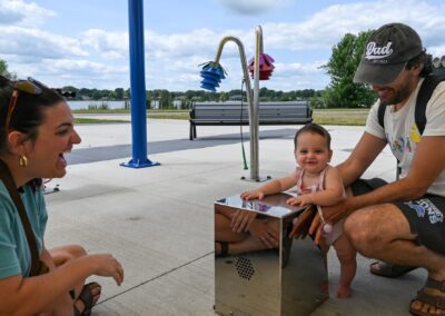 Couple with a toddler enjoying their time at a local park in Tomah, having fun.