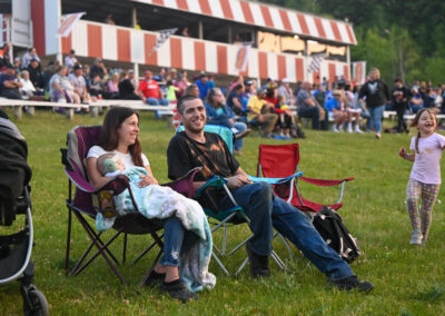 Couple laughing and relaxing in lawn chairs at a local race speedway