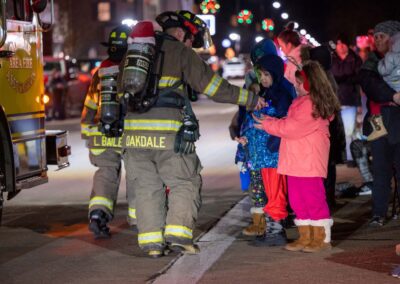 Fireman giving candy to children at a holiday parade