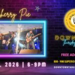 A poster with neon letters on it, which also includes a picture of the band Cherry pie.