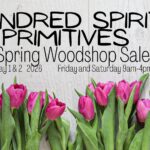 A poster with the event information on it and flowers on it.