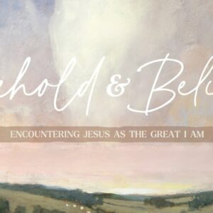 A poster with the event information on it in front of a field.