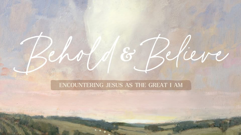 A poster with the event information on it in front of a field.