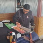 A photo showing a man making BBQ.