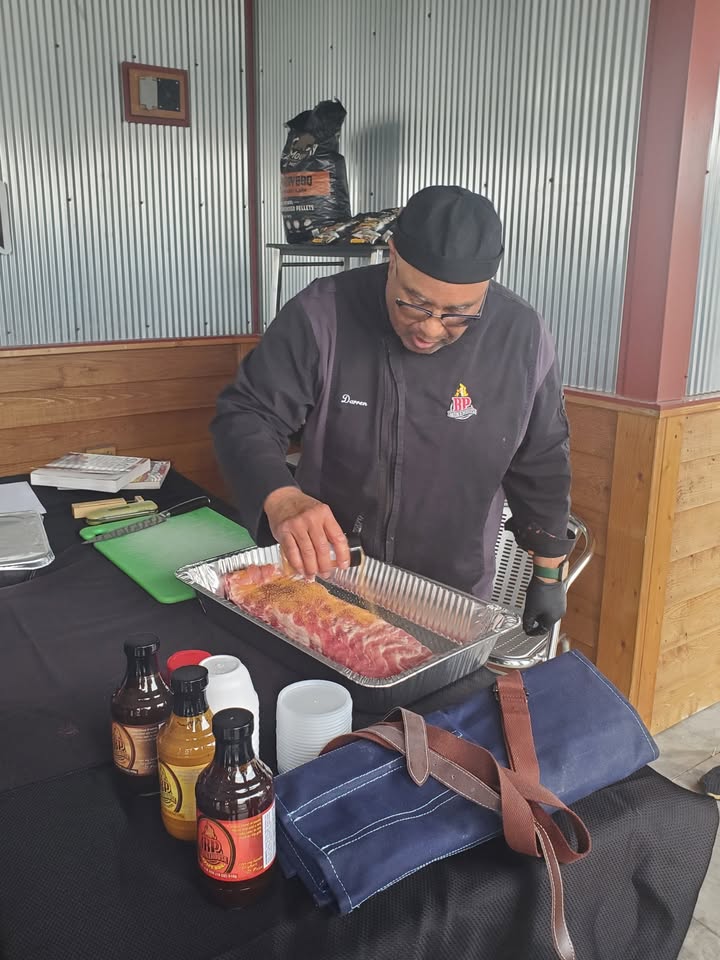 A photo showing a man making BBQ.