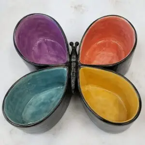 A multicolored ceramic serving dish shaped like a butterfly.