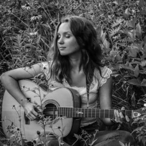 Musician Payton Eilers with her guitar