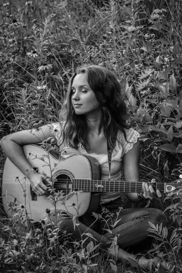 Musician Payton Eilers with her guitar