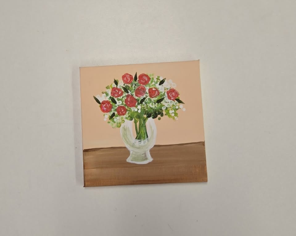 canvas painting of a vase full of roses