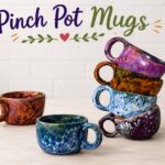 a stack of glazed pinch pot cups