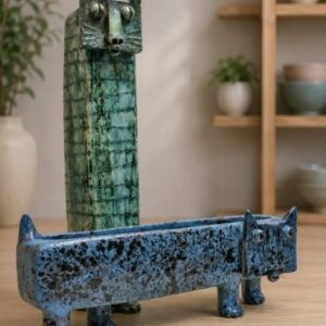 A tall vase and a wide planter both with cat faces.